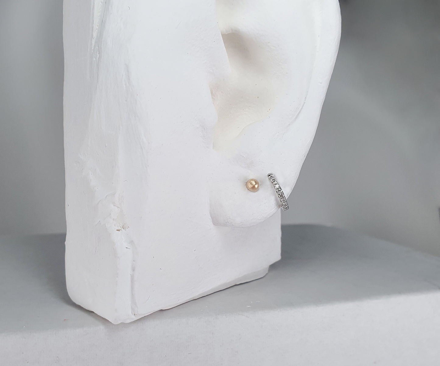 model shot of sentimental studs and diamond hoops