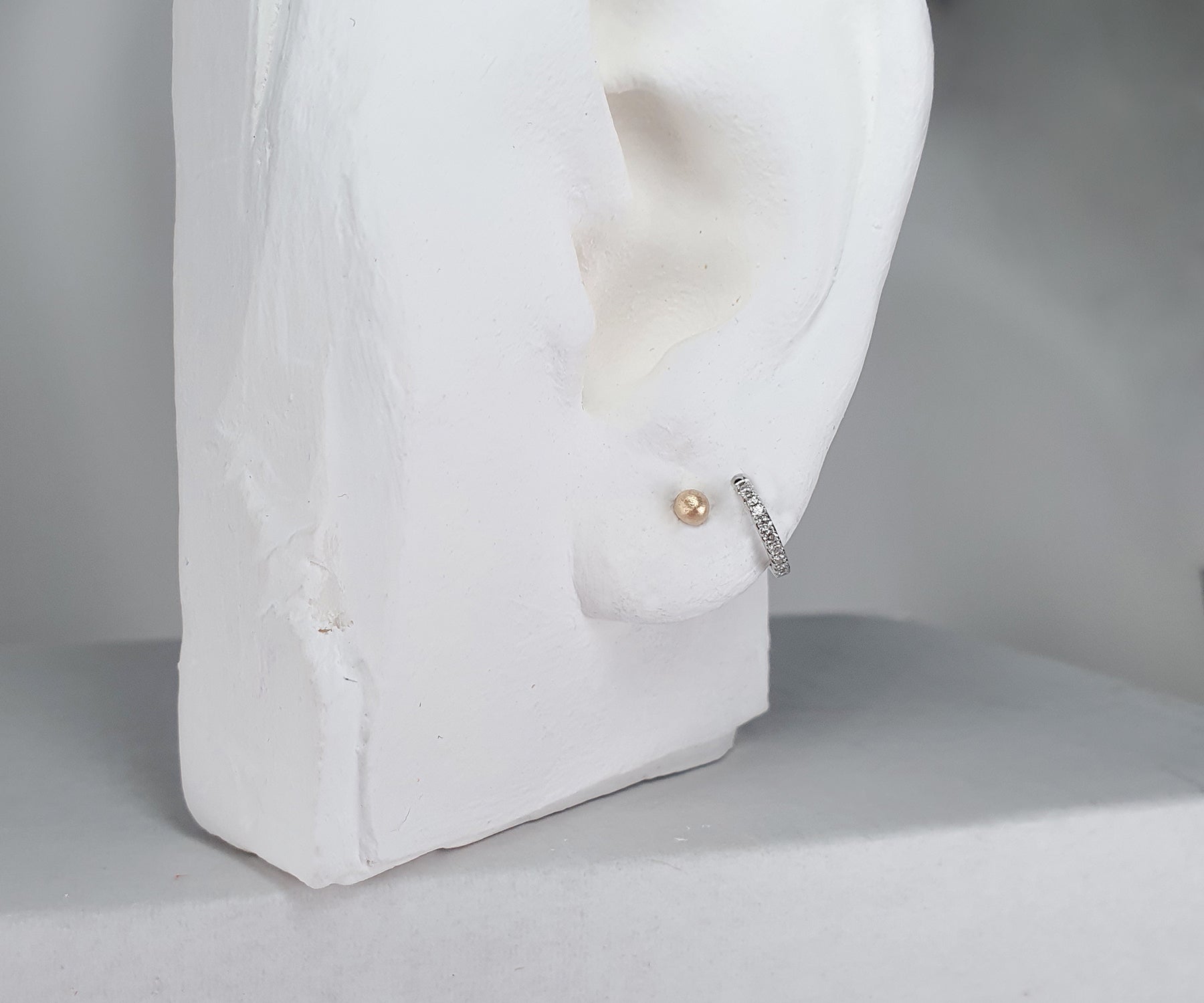 model shot of sentimental studs and diamond hoops